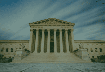 a large building with columns with United States Supreme Court Building in the background